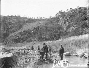African people standing on the bank of a river, Pretoria, South Africa, ca. 1896-1911