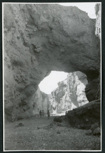 Photograph of three people walking in Natural Bridge Canyon in Death Valley