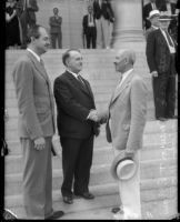 Mayor Shaw, A.F. Southwick, and David A. Smith stand together on the steps of city hall, Los Angeles, 1930s