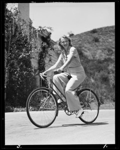Virginia Bruce and daughter Susan with their bicycles, 949 Las Lomas Avenue, Pacific Palisades, Los Angeles, CA, 1940