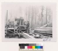 Portable mill of the Sacramento Mill & Lumber Company in the woods near Woodleaf. Very aromatic. Cost $35,000. Cuts good lumber with 2 men and fork lift man. June 1953. Metcalf