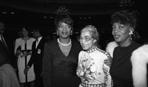 Rosa Parks posing with Oprah Winfrey and Maxine Waters at a Black Women's Forum event, Los Angeles