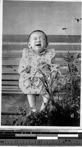 Child sitting on a bench crying, Japan, ca. 1920-1940