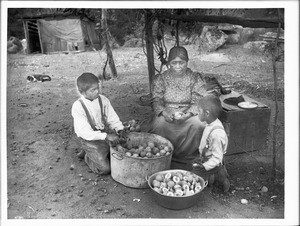 Yokut Indian women and two boys preparing peaches, Tule River Reservation near Porterville, California, ca.1900