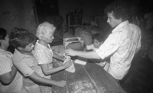 A woman receives food rations, Nicaragua, 1979