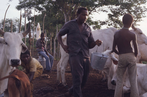Man walking with a milk bucket in his hand, San Basilio de Palenque, 1976