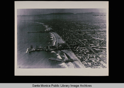 Aerial view of Santa Monica coastline including the Ocean Park Pier, Municipal Pier and the Malibu Pier on June 1, 1930