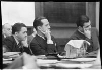 Accused murderer Paul A. Wright sitting with his attorneys in court, Los Angeles, 1938