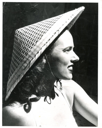 Portrait of unidentified woman with a woven hat