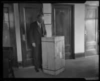District Attorney Asa Keyes receives a crate of evidence, Los Angeles, 1926