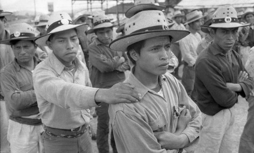 Mayan men stand in formation during a training by the army in civil defense, Chajul, 1982