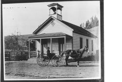 Man in horse and buggy in front of Coleman Valley School