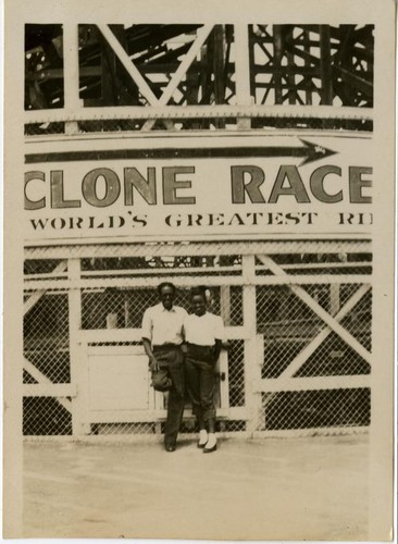 African American couple posed in front of the Cyclone Racer, Long Beach, CA, July 1949