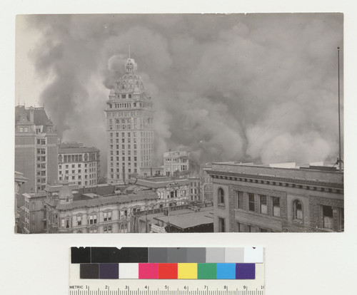 Market St. (3rd [Third], 4th [Fourth]). Note roofs of 2 bdg. injured by E.Q. see x on photo