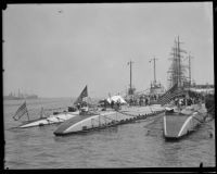 Seen from behind, three Navy submarines on display to the public in the San Pedro harbor, 1932