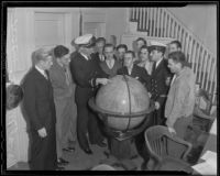 Navy officers provide instruction to militia recruits gathered around a globe, 1935