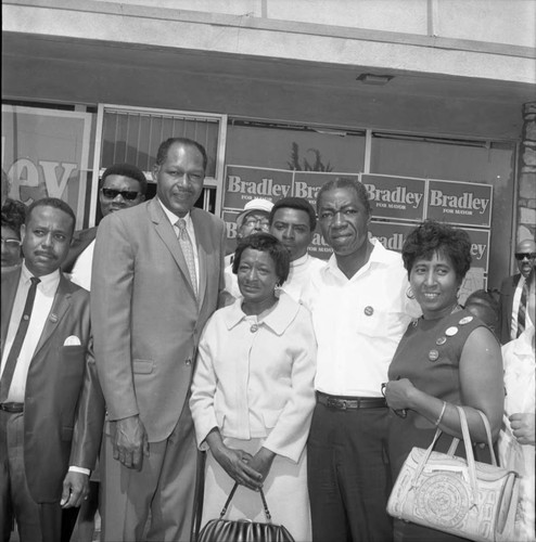 Tom Bradley posing with supporters in front of his campaign office , Los Angeles, 1969