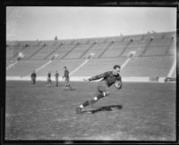 Football player Red Grange running, Los Angeles Coliseum, Los Angeles, 1926