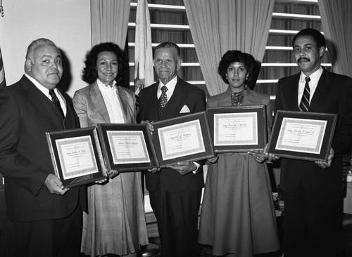 Judge Vaino Spencer and others posing with tributes from the Association of Black Law Enforcement Executives, Los Angeles, 1983