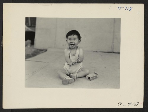 Manzanar, Calif.--Little evacuee of Japanese ancestry in a happy mood at this War Relocation Authority center. Photographer: Lange, Dorothea Manzanar, California
