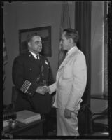 Chief of Police James E. Davis shakes hands with Volney P. Mooney, Jr., Los Angeles, 1935