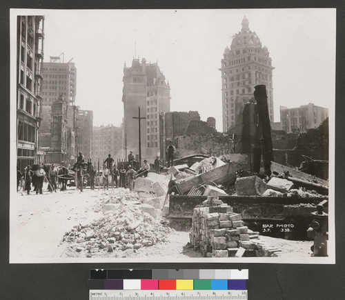 [Veiw southeast along Geary St. Clean-up crew posing, middle distance. In far distance: Palace Hotel, left center; Mutual Savings, center; and Call Building, right center.]