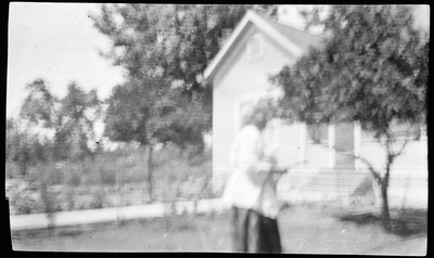 Woman in front of farm house