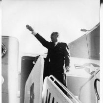 President Lyndon B. Johnson on a campaign visit to Sacramento, waves to crowd from the top of the steps of Air Force One as he gets ready to depart