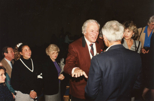 Photograph of Buddy Rogers greeting guests