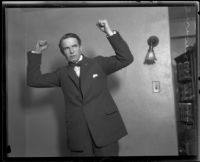 Distric Attorney Thomas Lee Woolwine with fists raised, Los Angeles, 1920-1923