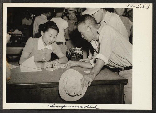 Residents of Colorado River Relocation Center for persons of Japanese ancestry requesting repatriation to Japan. Photographer: Stewart, Francis Poston, Arizona