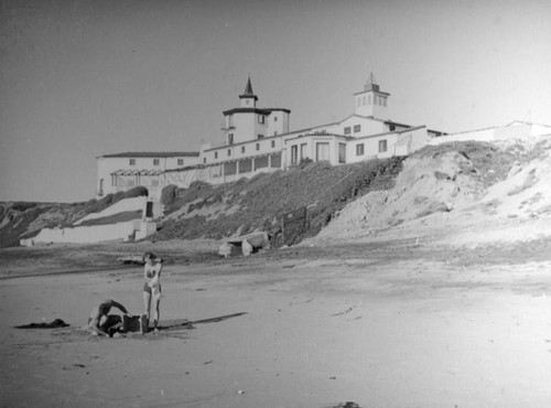 Couple in front of large building at the beach
