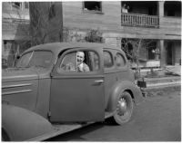 Unidentified photograph of man in car