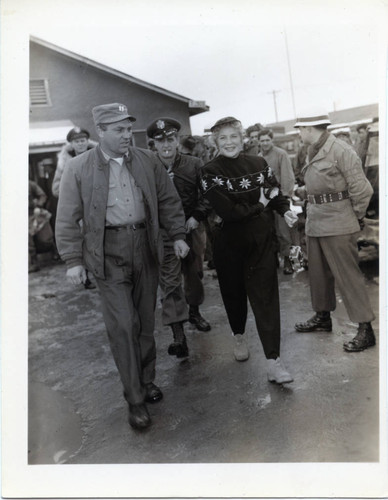 Betty Hutton being escorted upon arrival to Korea