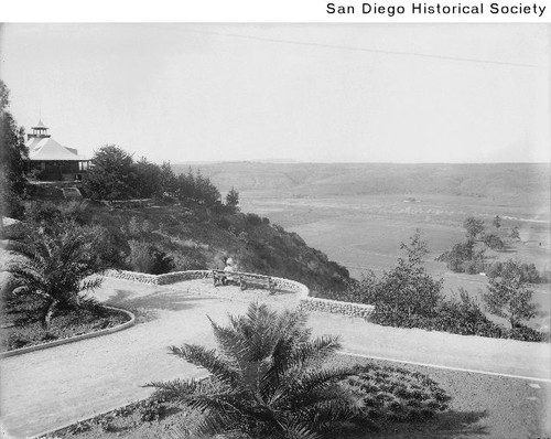 A couple seated on a bench overlooking Mission Valley at the Mission Cliff Gardens