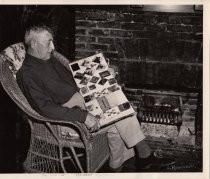 Lance Robinson with scrapbook, date unknown