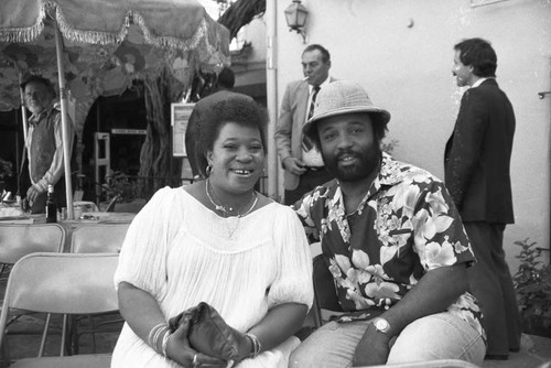 Andraé Crouch posing with a woman at a Los Angeles Press Club event, Los Angeles, 1983