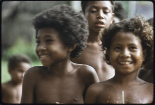 Dance: children beautified with coconut oil and yellow pollen, participating in dance