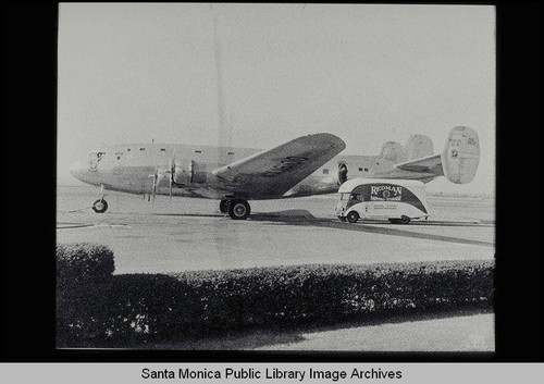 Redman Moving and Storage van with prototype of the DC4 airplane at Clover Field, Santa Monica, Calif