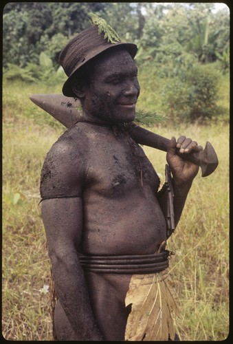 Basiitau painted black, wearing his very old cane hat