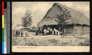 Thatched meeting room and assembled villagers, Angola, ca.1920-1940