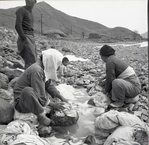Women doing laundry in a river bed