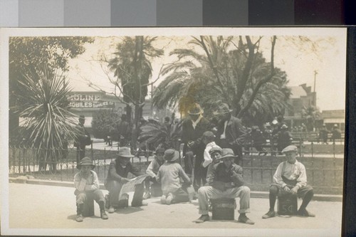 Shoe Blacks. Mexicans--Plaza. Los Angeles. 1911. [Shoeshine boys waiting to shine shoes in unidentified plaza.]