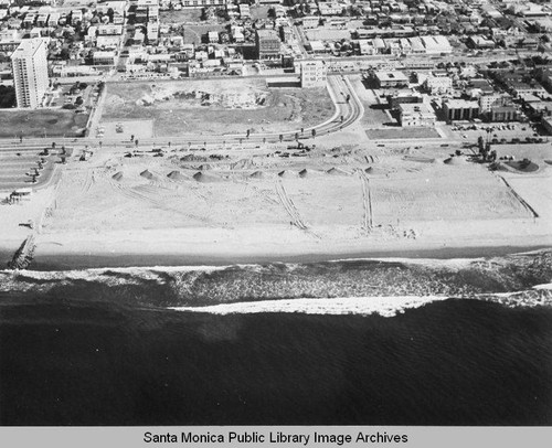 Looking east from the remains of the Pacific Ocean Park Pier to sand berms and the Santa Monica Shores high-rise, October 28, 1975