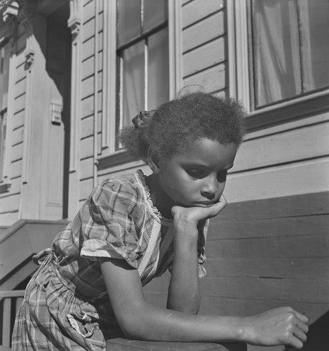 Black child leaning on arm, San Francisco
