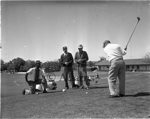 Playing golf, Los Angeles, 1963
