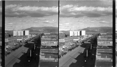 From corner of 3rd & Main St. in Grand Junction, Colo., looking up Main St. in horizon is Grand Mesa Mt