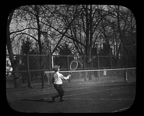 Young boy playing tennis
