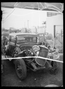 Wrecked car for advertisement, Southern California, 1936
