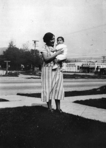 Woman with child in front yard